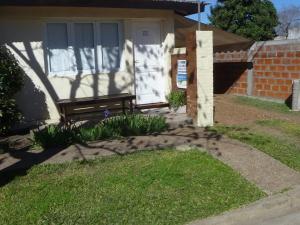 a bench sitting in front of a house at Lavandula in Villa Elisa