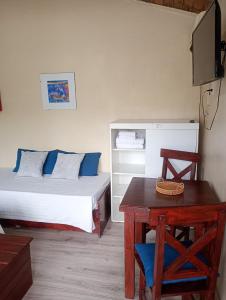 a bedroom with a bed and a table and a table sidx sidx sidx at Lavandula in Villa Elisa