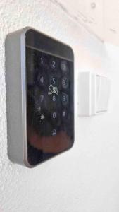 a close up of a remote control on a wall at Vivenda Alves in Charneca
