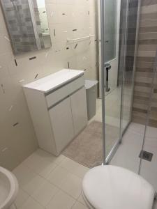 a bathroom with a toilet and a sink and a shower at Via Clitunno 24 in Foligno