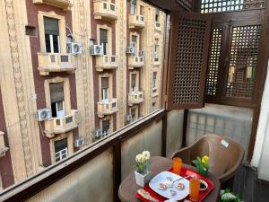 a table on a balcony with a view of a building at Kings palace castle in Cairo