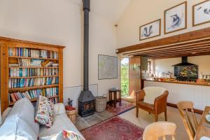 a living room with a couch and a wood stove at 2 Bed in Presteigne oc-75066 in Whitton