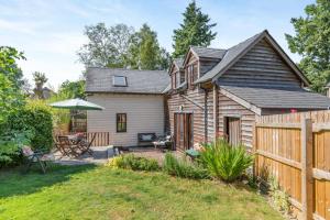 a wooden house with a patio and a fence at 2 Bed in Presteigne oc-75066 in Whitton