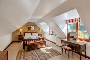 a bedroom with a bed and a desk and windows at 2 Bed in Presteigne oc-75066 in Whitton