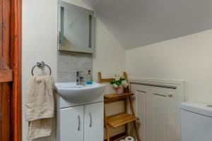 a small bathroom with a sink and a mirror at 2 Bed in Presteigne oc-75066 in Whitton +37 photos