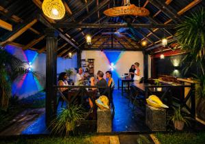 a group of people sitting at tables in a restaurant at elephant park family bungalow in Colombage-ara