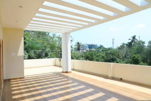 an empty balcony with a large skylight in a house at NJ Grand Villa in Kālapettai