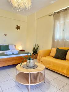 a living room with a couch and a table at Nomads in the south in Tsoutsouros
