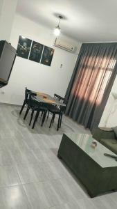 a living room with a table and a couch at Mostaganem sablette in Les Sablettes Mazagran-Plage