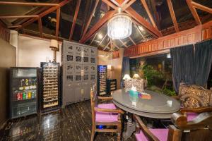 a room with a table and chairs in a room with a bar at Ladylagoon Luxury Multi-Purpose Private Beachfront Villas Koh Samui in Koh Samui