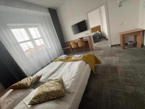 a bedroom with a large bed with pillows on it at Green Hotel in Świebodzin +8 photos