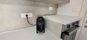 a phone plugged into a wall in a small room at Bardia Guest House in Dorgali