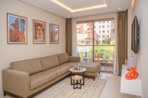 a living room with a couch and a table at Residence Eden Marrakech in Marrakesh