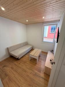 a room with a bed and a bench and a window at Agasallo Cedeira in Cedeira +1 photo