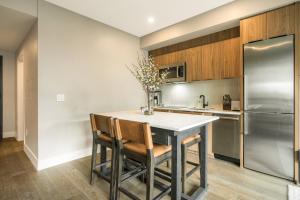 a kitchen with a table with chairs and a refrigerator at Kindred Resort, A RockResort in Keystone