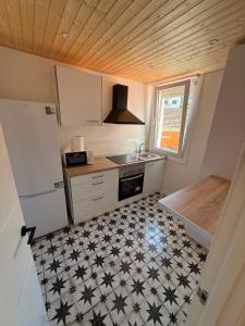 a small kitchen with a black and white tiled floor at Agasallo Cedeira in Cedeira