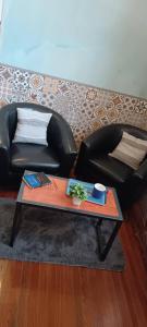 a living room with a couch and a coffee table at Tu casa en Montevideo in Montevideo