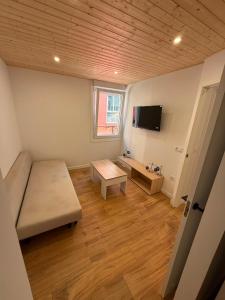 a small living room with a couch and a table at Agasallo Cedeira in Cedeira