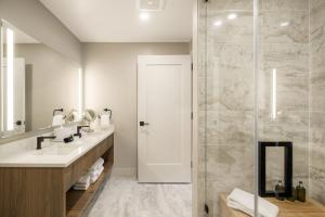 a bathroom with a sink and a shower at Kindred Resort, A RockResort in Keystone
