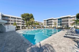 a swimming pool in front of a apartment building at Island Beach Club #P3E in Ybel