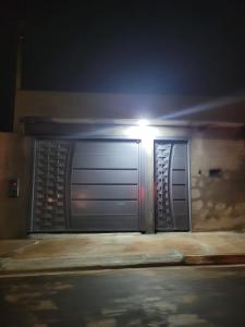 a metal door with a light on top of it at Lar Tranquilo Com Garagem in Pirassununga