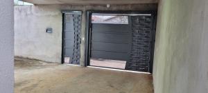 an empty garage with a sliding glass door at Lar Tranquilo Com Garagem in Pirassununga