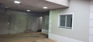 an empty room with a window on the side of a building at Lar Tranquilo Com Garagem in Pirassununga