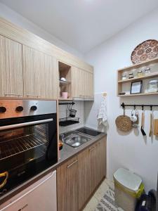 a kitchen with an oven and a sink in it at Apartments Dragulji Kruševac Central Stay in Kruševac +6 photos
