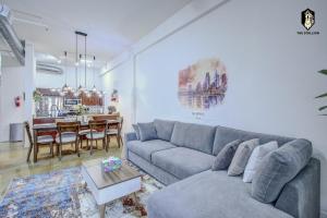 a living room with a couch and a table at The Stallion #101 - 1BD Modern Loft with Private Patio - Walk to various attractions in Memphis
