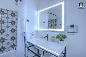 a bathroom with a sink and a mirror and a shower at The Stallion #101 - 1BD Modern Loft with Private Patio - Walk to various attractions in Memphis +13 photos