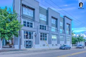 a building on a street with cars parked in front of it at The Stallion #101 - 1BD Modern Loft with Private Patio - Walk to various attractions in Memphis