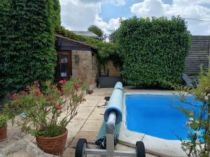 a pool in the backyard of a house at La Fleur de Lys in Moulins