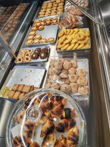 a buffet filled with lots of different types of pastries at B&B Il Dolce Castello di Balestrino in Balestrino