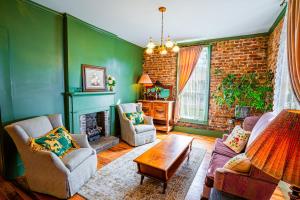 a living room with green walls and a fireplace at Cozy House with Private Sauna in Maryville