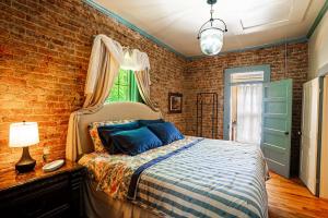 a bedroom with a bed and a brick wall at Cozy House with Private Sauna in Maryville