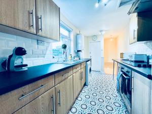 a kitchen with a sink and a counter top at Park Apartment 2, Close to Tynemouth in Tynemouth