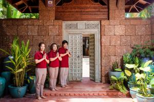 three women in red shirts standing in front of a building at Ladylagoon Luxury Multi-Purpose Private Beachfront Villas Koh Samui in Koh Samui +275 photos