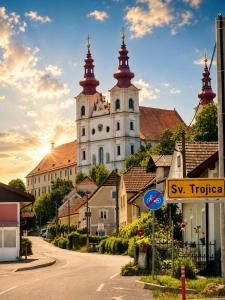 a large building with a street sign in front of it at Center Grič - sobe, apartma in Sveta Trojica v Slovenskih Goricah