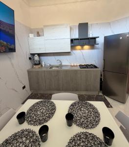 a kitchen with a table with chairs and a refrigerator at Vittoria & Celeste in Cervino