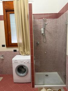 a washing machine in a bathroom with a shower at Vittoria & Celeste in Cervino +11 photos