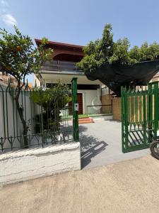 a green gate in front of a house at Vittoria & Celeste in Cervino