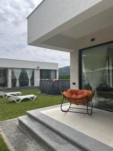 a basket sitting on a patio next to a building at Modern Mountain Villa with Pool near Tbilisi in Bulach'auri