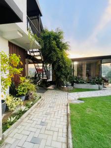 a house with a patio and a staircase in the yard at Kandyan Lounge in Kiribatkumbura