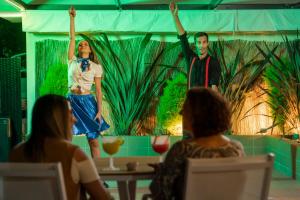 a group of people sitting around a table watching a presentation at Dorisol Estrelicia Hotel in Funchal +62 photos