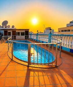 a pool on the deck of a cruise ship at sunset at Elite Jonrad Hotel LLC in Dubai