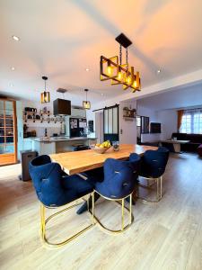 a kitchen and dining room with a wooden table and chairs at BIOTY CHILL & SPA in Le Blanc-Mesnil