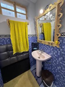 a bathroom with a sink and a mirror at Gite Souran Imsker in Tagadirt Aït Ali