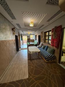 a living room with a couch and a table at Gite Souran Imsker in Tagadirt Aït Ali