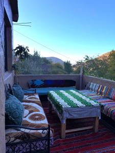 a row of benches sitting on a balcony at Gite Souran Imsker in Tagadirt Aït Ali