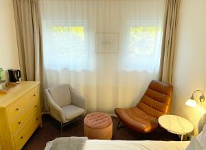 a bedroom with a bed and a chair and a desk at Achilla Bed & Breakfast in Český Krumlov
